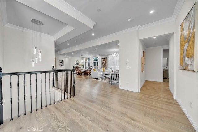 corridor featuring light wood-type flooring and crown molding