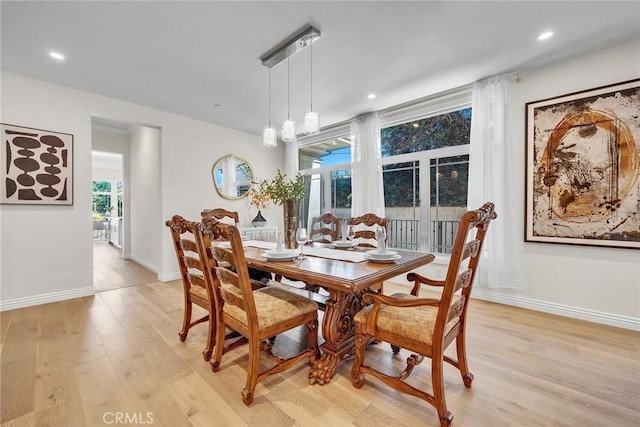 dining space featuring light wood-type flooring