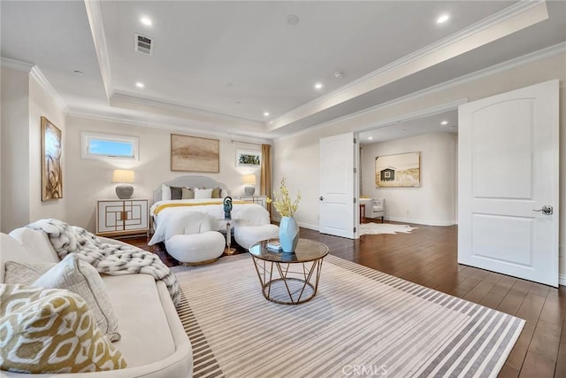 bedroom with dark wood-type flooring, multiple windows, a tray ceiling, and crown molding