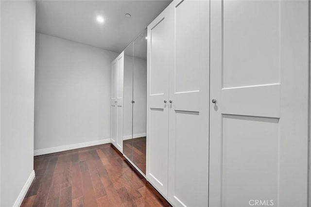 hallway featuring dark hardwood / wood-style flooring