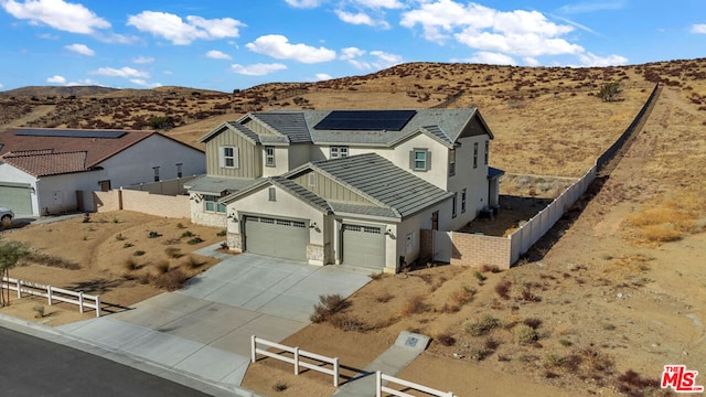 view of front facade with a mountain view and a garage