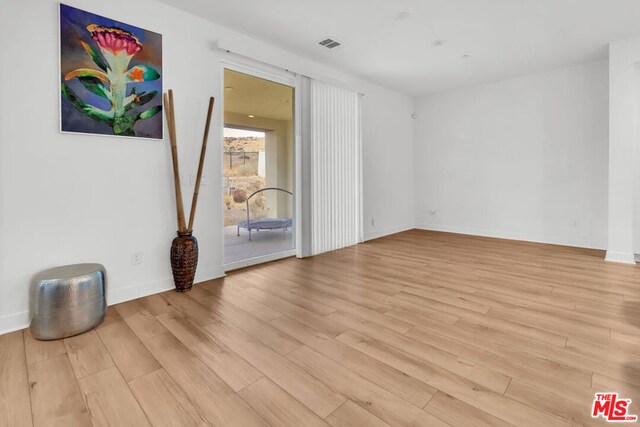 spare room with light hardwood / wood-style flooring