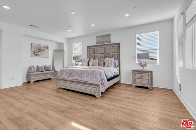 bedroom featuring light hardwood / wood-style floors and multiple windows