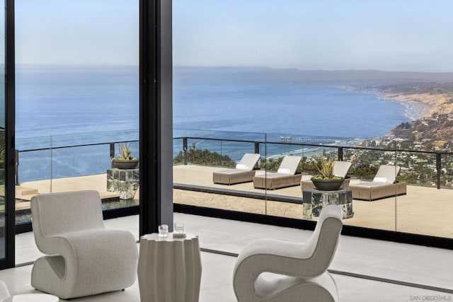 balcony featuring a water view and a view of the beach