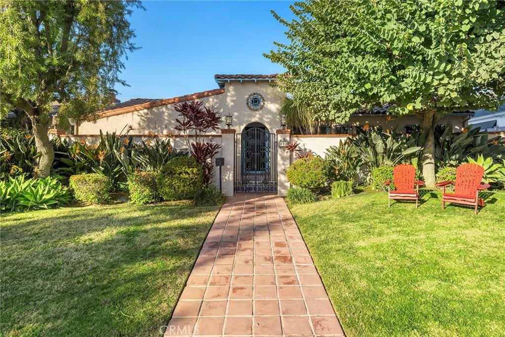 mediterranean / spanish-style house with a front lawn