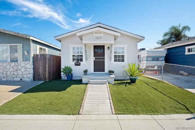 bungalow-style house featuring a front lawn