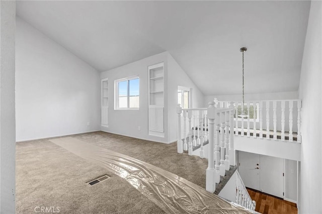 interior space featuring lofted ceiling and built in features