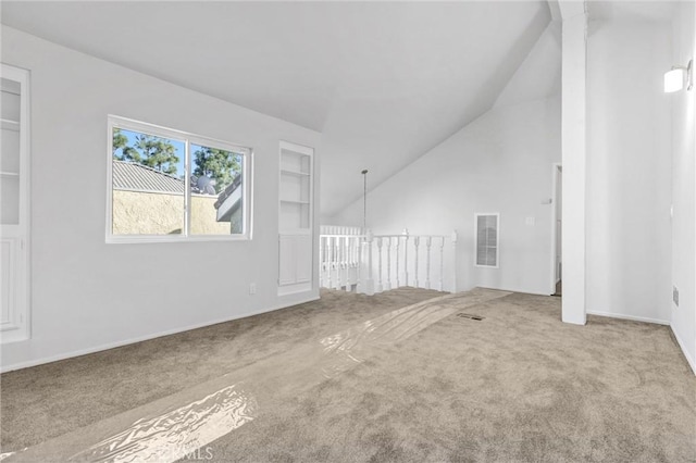 unfurnished living room with carpet flooring, built in features, and vaulted ceiling