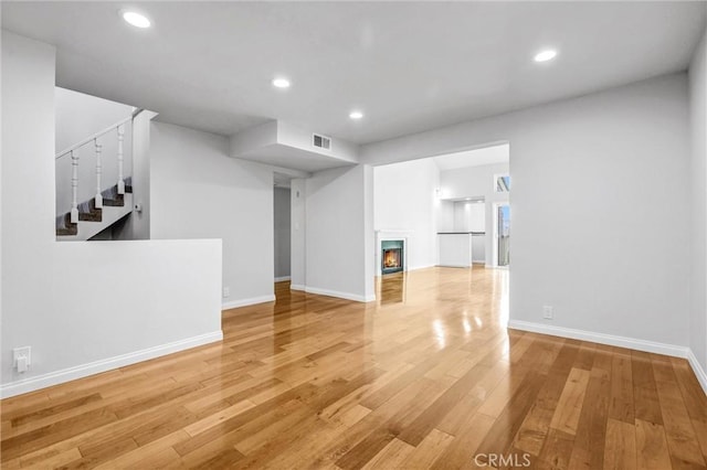 unfurnished living room featuring wood-type flooring