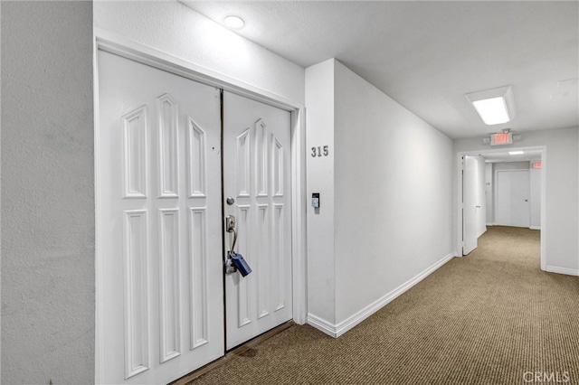 hallway with carpet floors