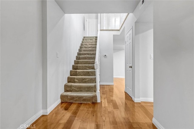 stairs with hardwood / wood-style flooring