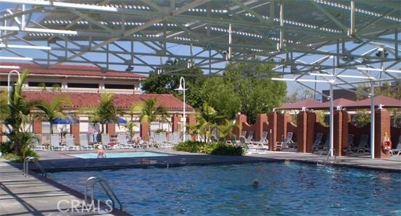 view of swimming pool featuring a water view