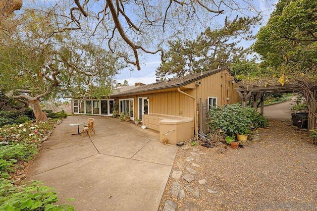 ranch-style house featuring a sunroom and a patio