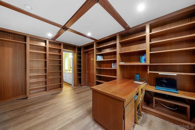 office area with light wood-type flooring and beam ceiling