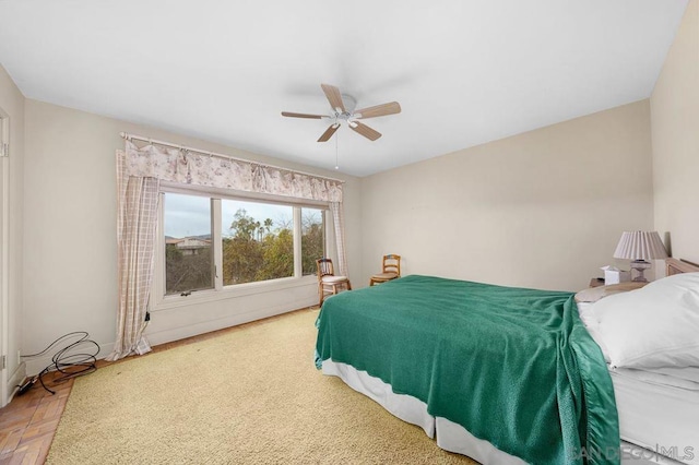 bedroom with ceiling fan and parquet floors