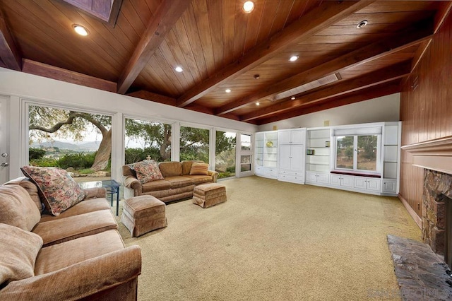 sunroom / solarium featuring lofted ceiling with skylight, wood ceiling, and a fireplace