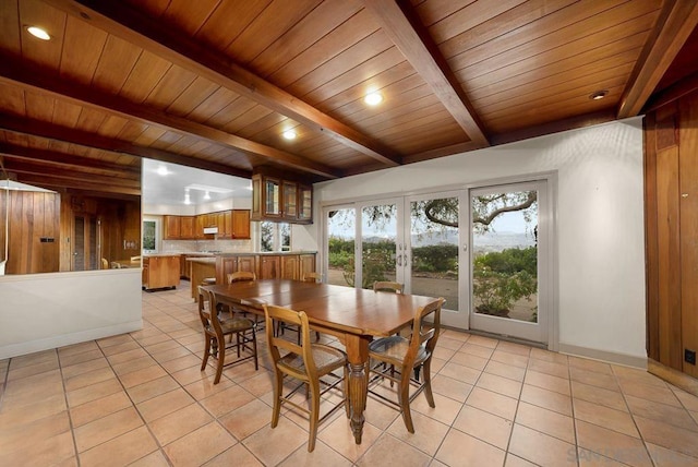 dining space with french doors, light tile patterned flooring, beamed ceiling, and wooden ceiling