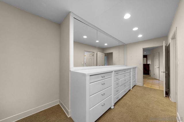 spacious closet with light colored carpet