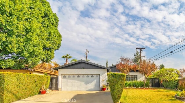 ranch-style house featuring a garage and a front lawn