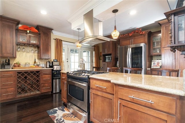 kitchen with island range hood, appliances with stainless steel finishes, dark wood-type flooring, ornamental molding, and pendant lighting