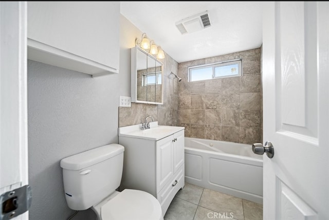 full bathroom with tile patterned floors, toilet, vanity, and tiled shower / bath