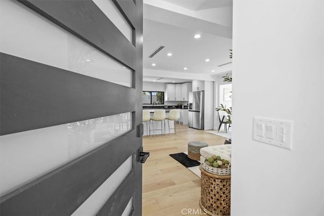 corridor with light hardwood / wood-style flooring