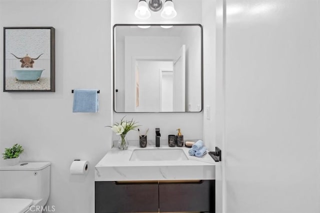 bathroom featuring toilet and vanity