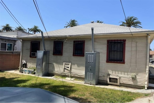 rear view of house with a yard