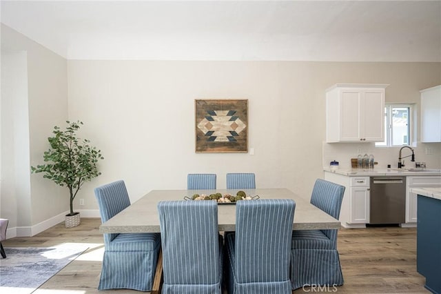 dining room with sink and light hardwood / wood-style floors