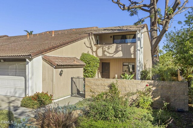 view of front of home featuring a balcony and a garage