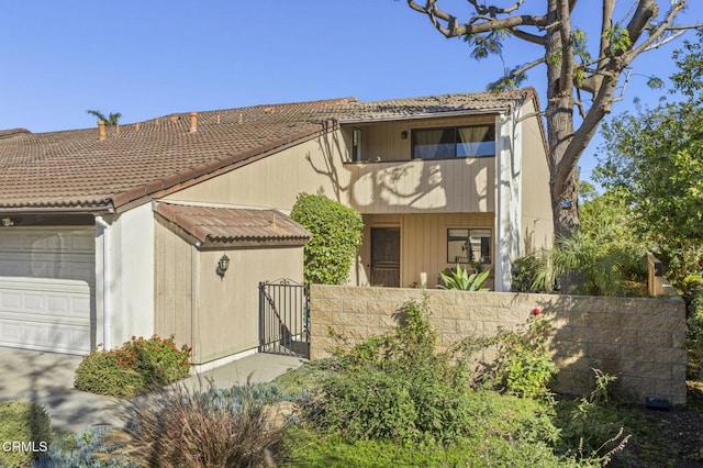 view of front of property featuring a garage and a balcony