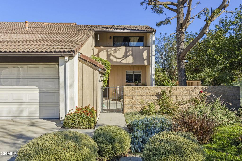 view of front of property featuring a balcony and a garage