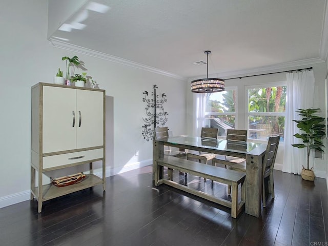 dining room with dark hardwood / wood-style flooring, crown molding, and a notable chandelier