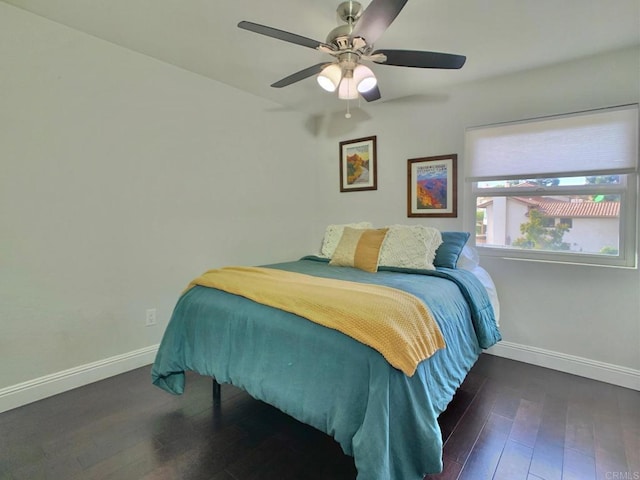 bedroom with ceiling fan and dark wood-type flooring