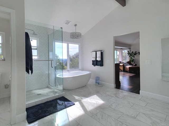 bathroom with separate shower and tub, a wealth of natural light, and vaulted ceiling with beams