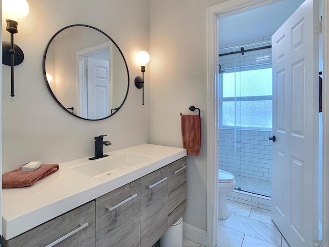 bathroom featuring toilet, vanity, tile patterned flooring, and a tile shower