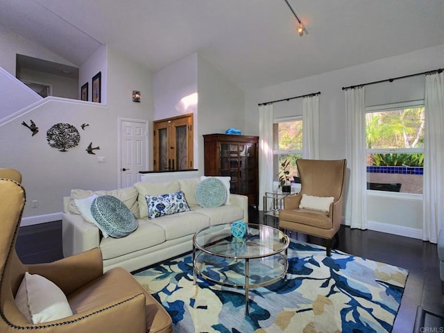 living room with dark hardwood / wood-style floors and lofted ceiling