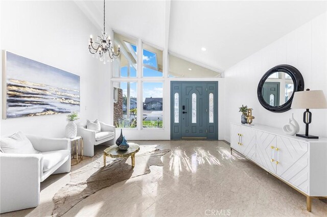 foyer featuring high vaulted ceiling and an inviting chandelier