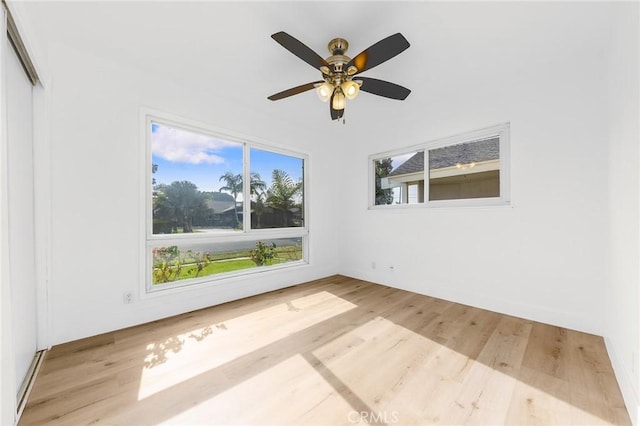 empty room featuring ceiling fan and light hardwood / wood-style flooring