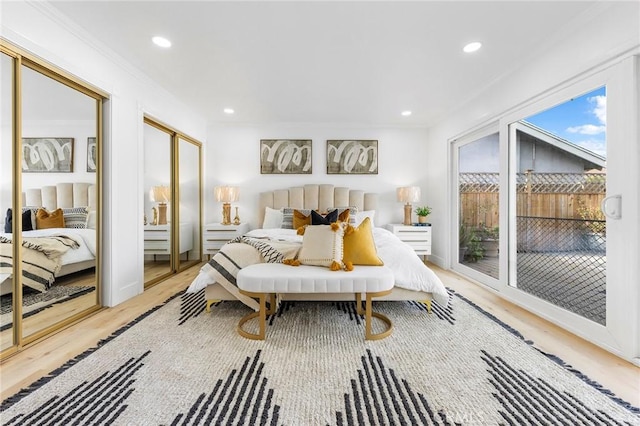 bedroom featuring ornamental molding and light hardwood / wood-style flooring