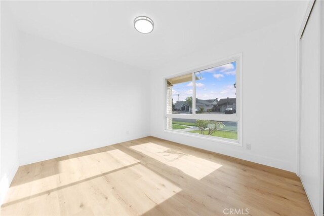 spare room featuring light hardwood / wood-style flooring