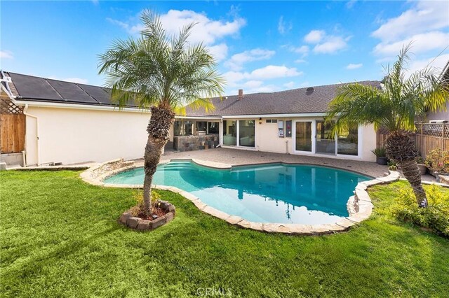 view of swimming pool with a patio area and a lawn