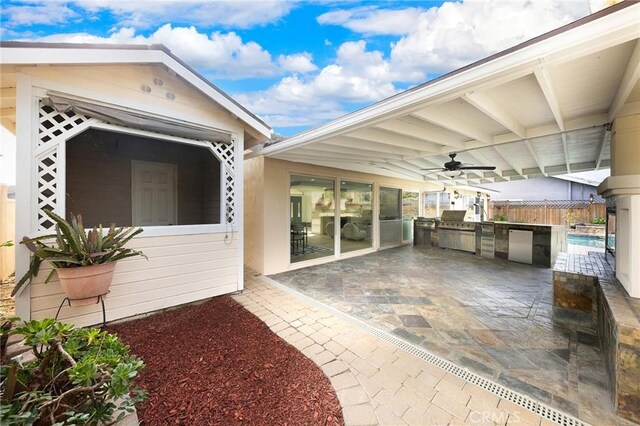 view of patio with ceiling fan and exterior kitchen