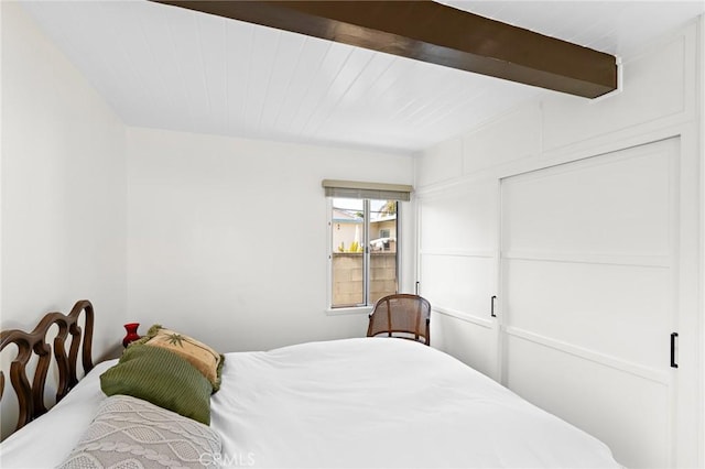 bedroom with beam ceiling