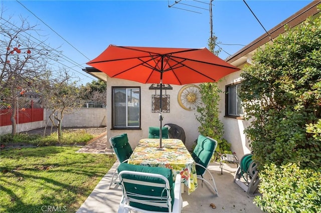 view of patio / terrace with outdoor dining space and fence