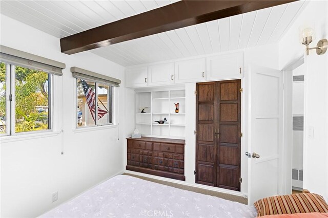 bedroom featuring beamed ceiling