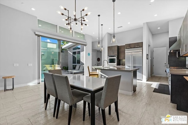 dining room with a notable chandelier and sink