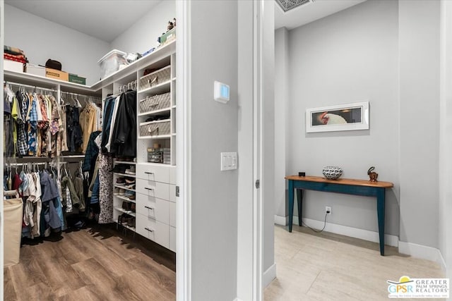 spacious closet featuring hardwood / wood-style floors