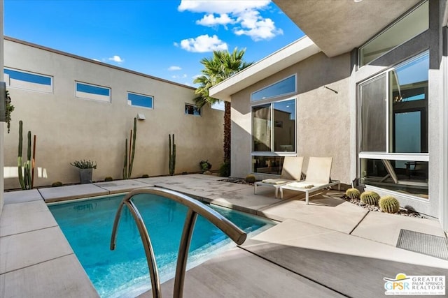 view of swimming pool with a patio area