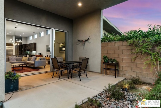 patio terrace at dusk featuring an outdoor living space